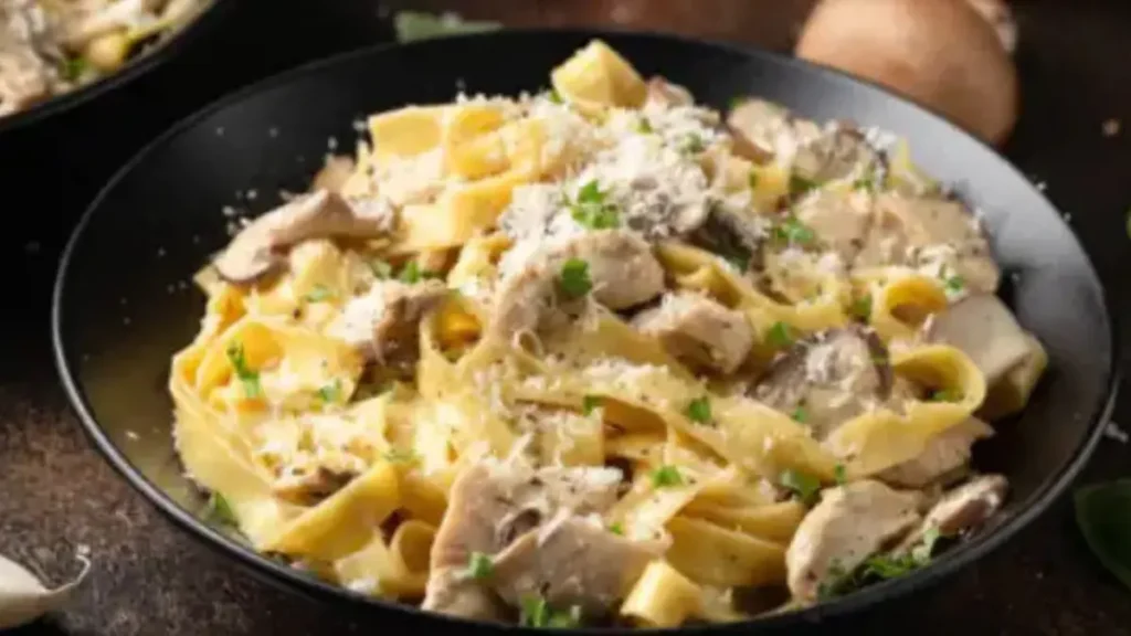 A creamy garlic Parmesan chicken pasta with tender chicken pieces, coated in a rich sauce and topped with grated Parmesan and fresh parsley