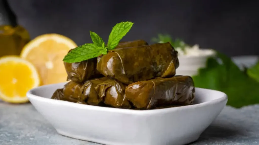 a plate of dolmas, stuffed grape leaves filled with a savory mixture, typically rice, herbs, and sometimes meat.